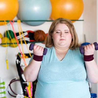 An overweight guest working hard to improve her body at Weight Crafters
