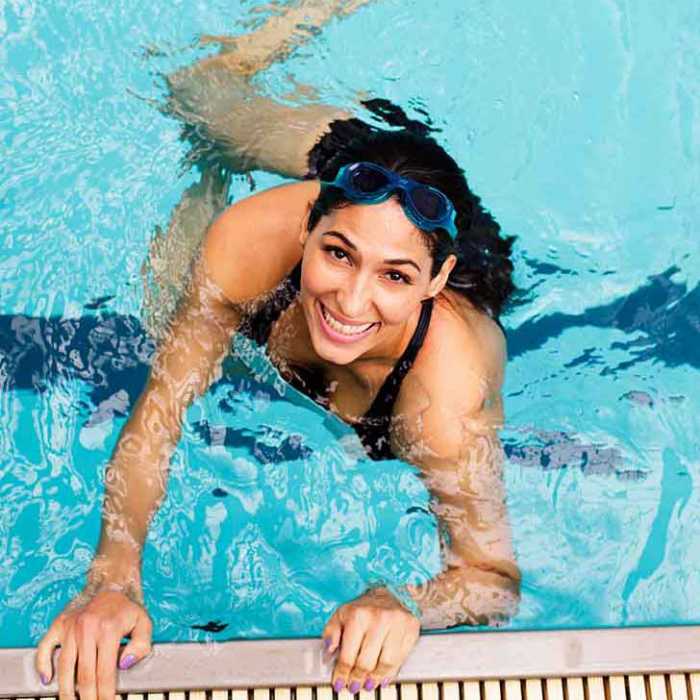 A younger woman enjoying the pool during a water aerobics session at Weight Crafters